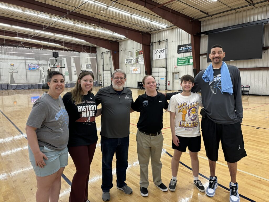 Basketball coaches and players catching up at a reunion.